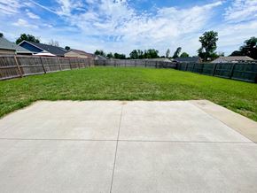 Louisville house for rent - a backyard with a yard and a fence and a grassy area