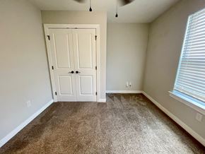 Louisville house for rent - an empty bedroom with carpet and a door