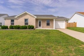 Louisville house for rent - a brick house with a sidewalk in front of it