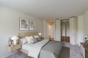 Baltimore apartment for rent - A bedroom with a large bed and a wooden headboard.