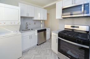 Baltimore apartment for rent - a white kitchen with a stove and a microwave