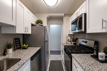Baltimore apartment for rent - A modern kitchen with granite countertops and stainless steel appliances.