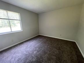 Louisville house for rent - an empty room with carpet and a window