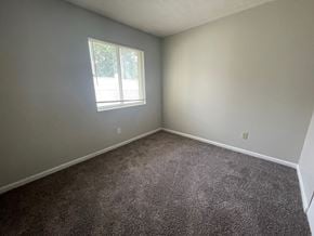 Louisville house for rent - an empty room with carpet and a window