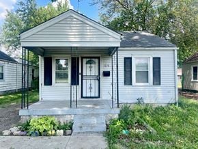 Louisville house for rent - the front of a white house with a black door