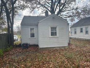 Louisville house for rent - a small white house in a yard with some trees
