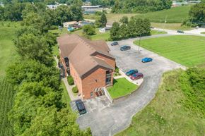 Salem apartment for rent - an aerial view of a church with a brick building and a parking lot