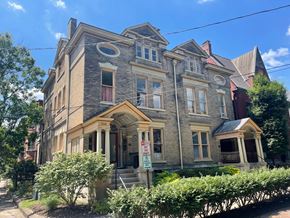 Louisville apartment for rent - A large, old building with a sign on the front.