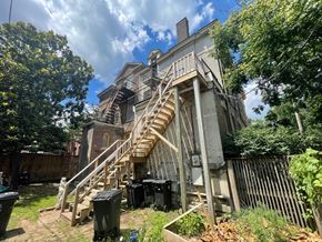 Louisville apartment for rent - A large, old building with a wooden staircase outside.