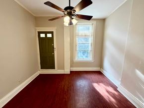 Louisville apartment for rent - A room with a ceiling fan and a window with blinds.
