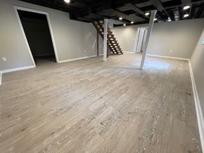 Louisville house for rent - A room with wooden flooring and a staircase in the corner.