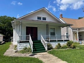 Jeffersonville apartment for rent - a white house with a porch and green stairs