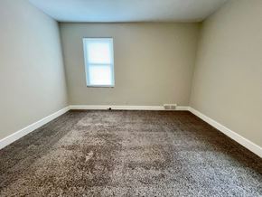 Louisville apartment for rent - A room with a carpeted floor and a window.