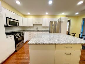 Louisville apartment for rent - A kitchen with white cabinets and a granite countertop.