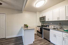 Cherry Hill apartment for rent - a kitchen with stainless steel appliances and white cabinets