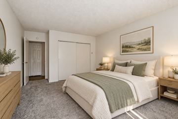 Cherry Hill apartment for rent - A bedroom with a large bed and a painting on the wall.