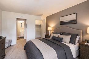 Dover apartment for rent - A bedroom with a large bed and a painting on the wall.