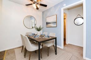 Dover apartment for rent - A dining room with a table set for two and a ceiling fan.