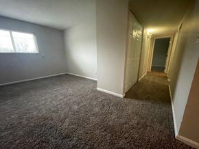 Louisville apartment for rent - A room with a carpeted floor and a window.