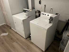 Louisville apartment for rent - Two white appliances in a room with wood flooring.