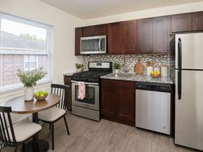 Westfield apartment for rent - A kitchen with a table and chairs and a refrigerator.