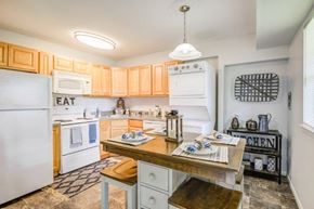 Eastampton apartment for rent - a kitchen with white appliances and wooden cabinets