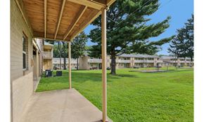Eastampton apartment for rent - A view of a porch with a green lawn and trees in the background.