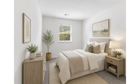 Eastampton apartment for rent - A bedroom with a bed, nightstand, and a plant.
