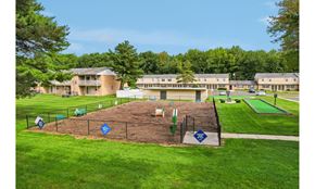 Eastampton apartment for rent - A playground area with a blue sign in the middle of a grassy field.