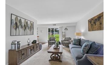 Eastampton apartment for rent - A living room with a blue couch and a wooden cabinet.