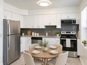 Eatontown apartment for rent - A modern kitchen with a table set for two.