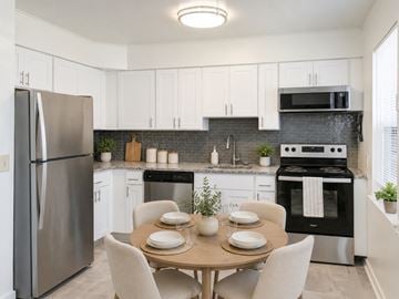 Eatontown apartment for rent - A modern kitchen with a table set for two.