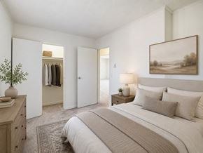 Eatontown apartment for rent - A bedroom with a large bed and a painting on the wall.