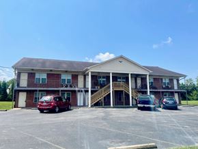 Shepherdsville apartment for rent - a parking lot in front of a building with cars