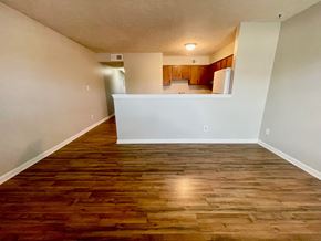 Shepherdsville apartment for rent - an empty living room with wood flooring and a kitchen