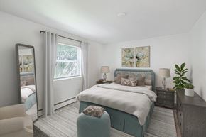 Long Branch apartment for rent - a bedroom with a bed and a dresser and a mirror