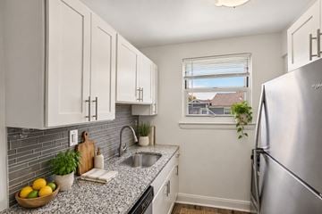 Elmwood Park townhouse for rent - A kitchen with a refrigerator, sink, and cabinets.