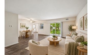 Blackwood apartment for rent - A living room with a white couch, a coffee table, and a dining table with chairs.