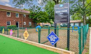 Springfield apartment for rent - a dog park with a sign in front of a brick building