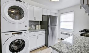 Springfield apartment for rent - a white kitchen with a washing machine and a refrigerator