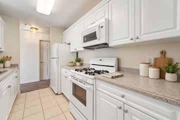 Franklin Lakes apartment for rent - A white kitchen with a stove, oven, and microwave.