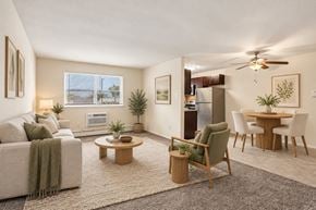 Bellmawr apartment for rent - A living room with a couch, chairs, and a dining table.