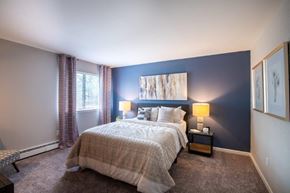 Middletown apartment for rent - a bedroom with a bed and a blue accent wall