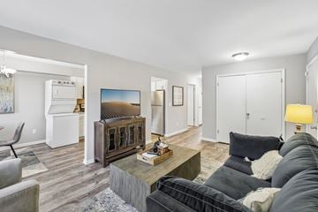 Middletown apartment for rent - A living room with a black couch and a wooden coffee table.