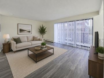 Cherry Hill apartment for rent - A living room with a couch, coffee table, and a painting on the wall.