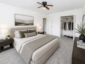 Cherry Hill apartment for rent - A bedroom with a large bed and a ceiling fan.