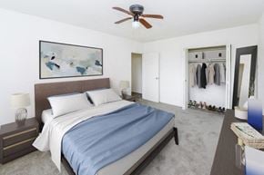 Cherry Hill apartment for rent - a bedroom with a bed and a ceiling fan