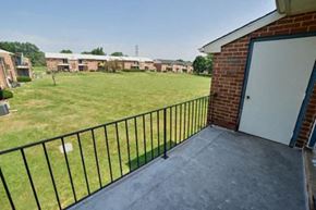 Wilmington apartment for rent - a balcony with a garage door and a grass field