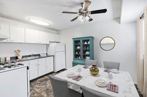 Wilmington apartment for rent - a kitchen with white cabinets and a table