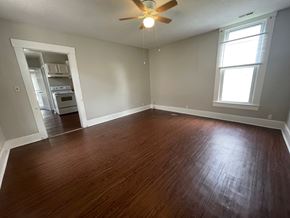 New Albany apartment for rent - A room with a ceiling fan and a window.